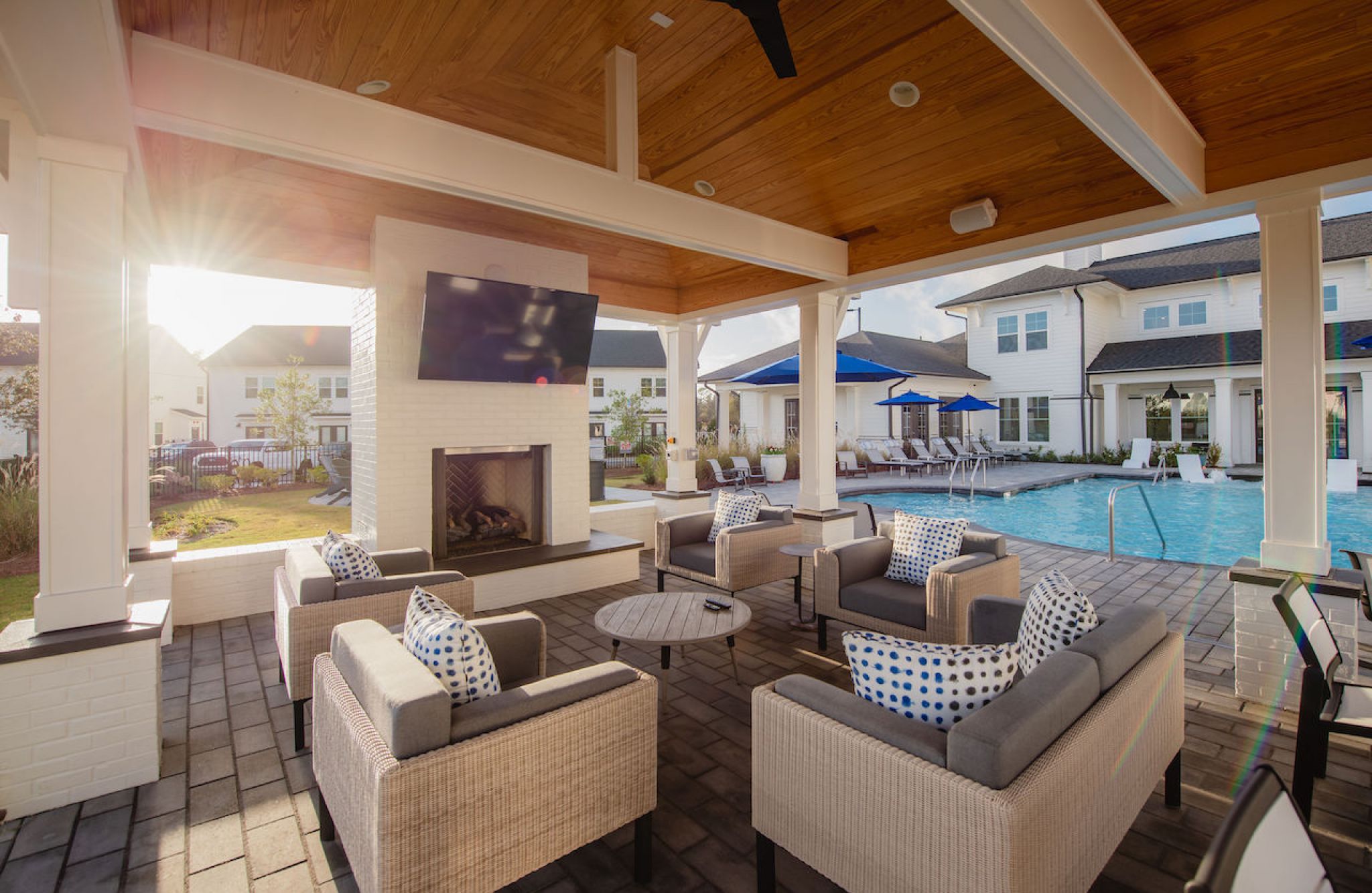 Hawthorne at the Pointe luxury outdoor pool area pavilion with lounge seating, fireplace, and TV